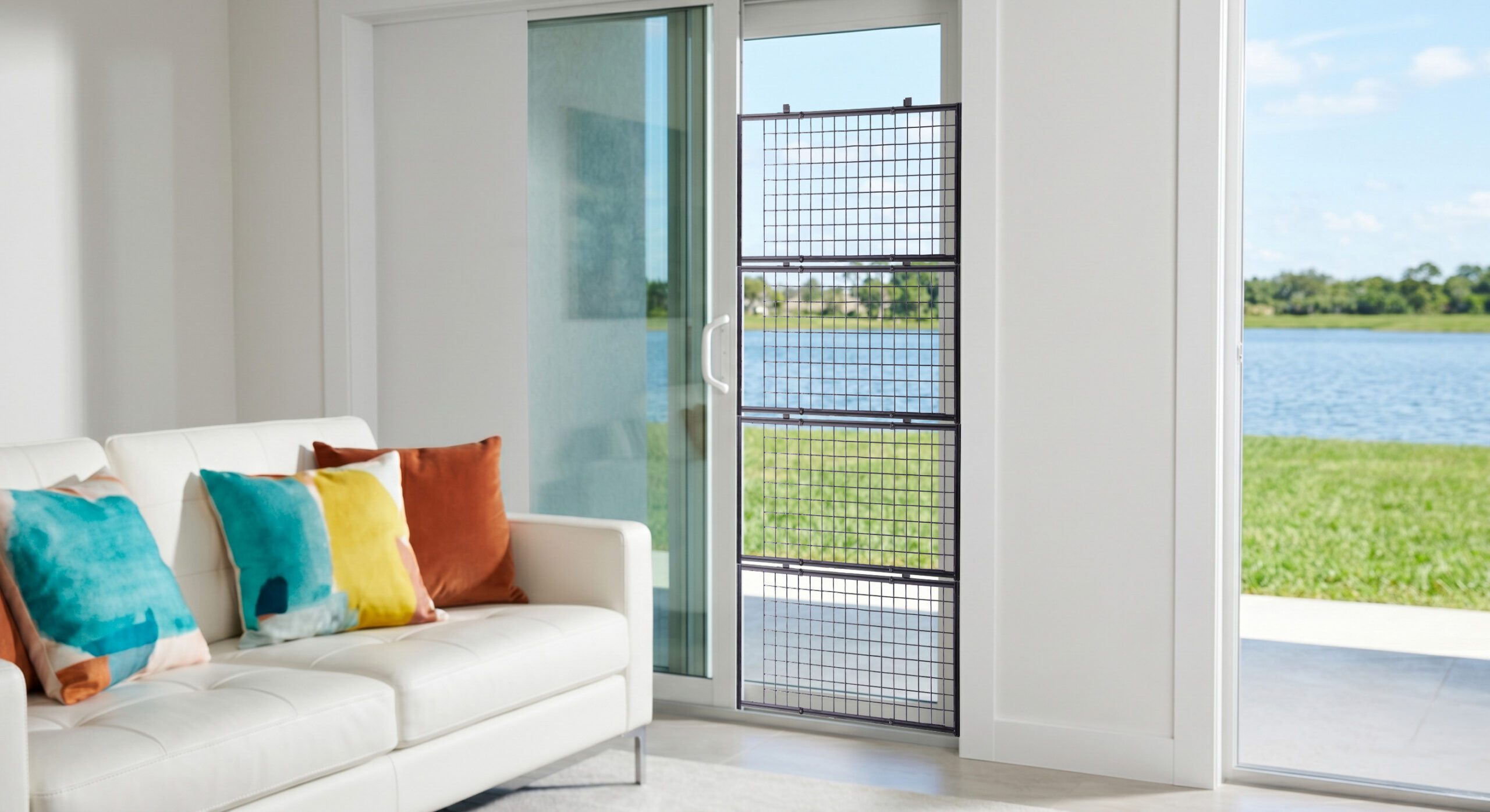 Sofa with colorful pillows by sliding door